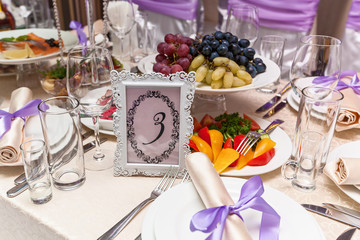 A decorated wedding table with a seat number five. Served wedding table.
