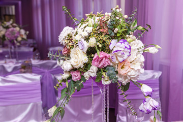 A wedding bouquet is on the table in the background of the hall. Bridal bouquet.