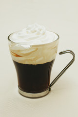 glass of coffee and cream on white background