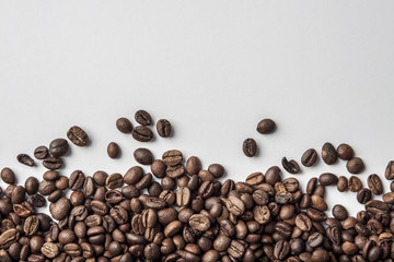 Spilled coffee in grains and white background as space for text