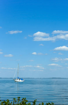 A lone yacht on the horizon. The yacht with masts lonely swims.