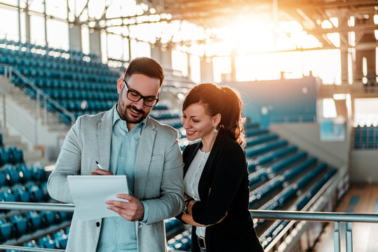 Two Business People Organizing An Event In Sport Hall.