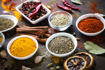 Set of Various spices on dark stone table.