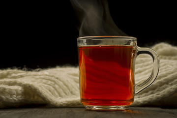     Cup with scarf with hot tea.