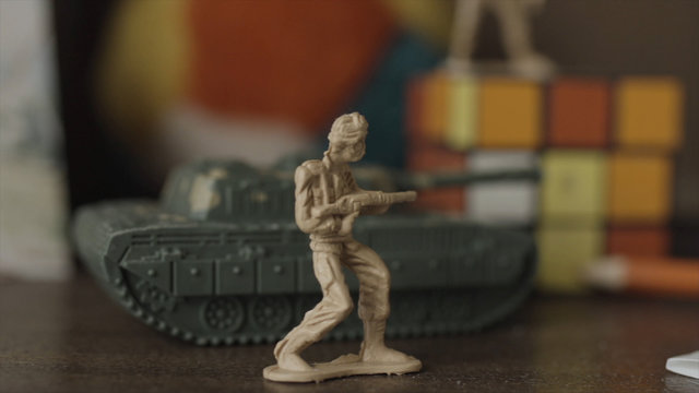 Baby toy - soldiers. Old forgotten toy on the shelf at home. The concept of childhood