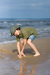 The guy is happy on the sandy beach of the sea.