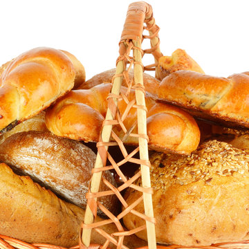 Bread and baked goods in a wicker basket isolated on a white background