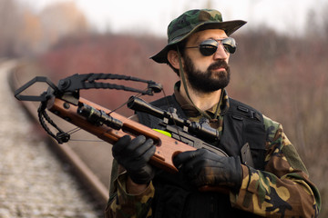 military man with crossbow