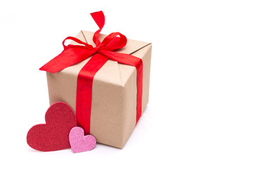 gift box with red ribbon and two red heart inscription love on Valentine's day feast