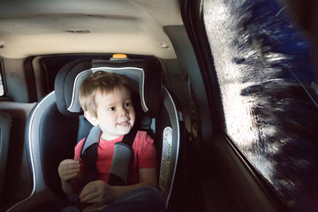 Toddler boy watching inside a car wash