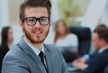 Portrait of an handsome businessman in front of his team.