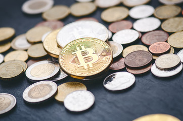 Golden bitcoin coins on a dark background with euro coins.  Virtual currency. Crypto currency. New virtual money. Lens flare 