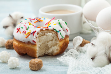 Donuts with icing on a white table, white eggs, Easter concept Menu, restaurant recipe concept Served in