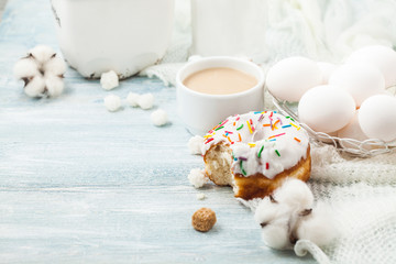 Donuts with icing on a white table, white eggs, Easter concept Menu, restaurant recipe concept Served in. Space for text
