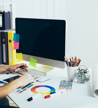 Young Handsome Graphic designer using graphics tablet to do his work at desk
