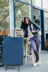 Young pretty spanish woman in cafe in city centre