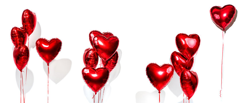 Valentine's Day. Set of air balloons. Bunch of red heart shaped foil balloons isolated on white background