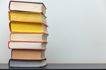 a stack of old colorful books on the table