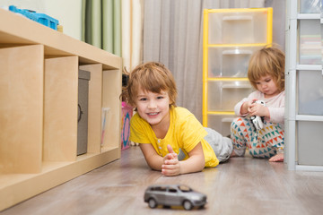 little children play  with toy car at home
