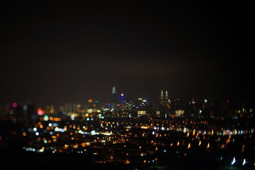 Obraz premium Blurred dramatic night view of city with abstract of LED, neon lights and beautiful bokeh.