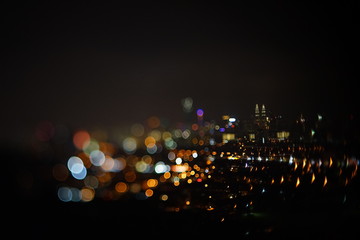 Blurred dramatic night view of city with abstract of LED, neon lights and beautiful bokeh.