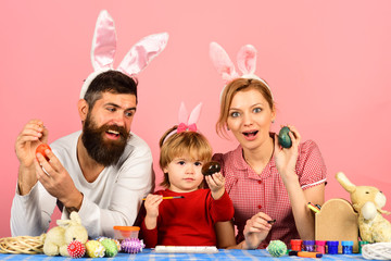 Man with beard, woman and kid wearing bunny ears