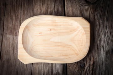 Old wooden utensils on a brown table.