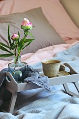 Coffee in bed with flowers. Romantic breakfast in bed