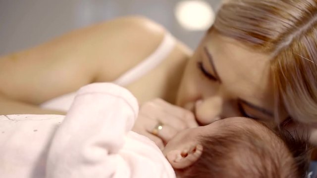 Close up shot of a beautiful mother and her lovely child lying together in bed.