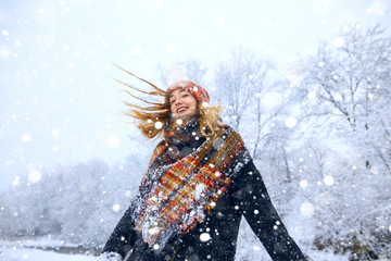 Young woman winter portrait. Expressing positivity, true brightful emotions. Beautiful model girl with shiny red long hair