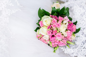 Bouquet flowers of roses, isolated on white lace background