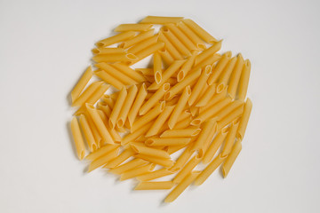 Dried rigatoni pasta on white background