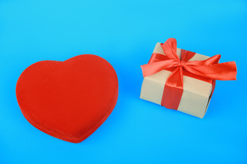 heart shaped box and present wrapped with red ribbon