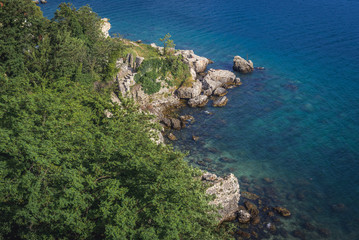 Fototapeta na wymiar Rocky shore of Herceg Novi coastal town at the entrance to Kotor Bay in Montenegro