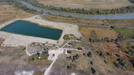 Obraz premium Houses on the basis of rest. Homes for tourists and hunters. The hostel. Infrastructure for stopping tourists and hunters and fishermen. Houses, paths, platforms for walking and leisure.