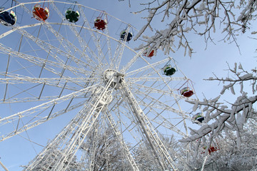 Ferris wheel in the snow. Fragment of the wheel in the winter park.