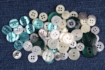 different mother of pearl buttons on blue fabric