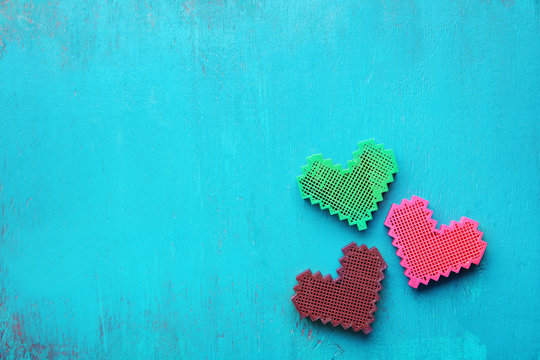 Color hearts on wooden background