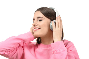 Young beautiful woman with headphones listening to music and smiling on white background