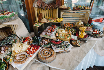 decorated catering banquet table with snacks and different food