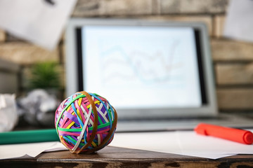 Colorful rubber bands with laptop on desk