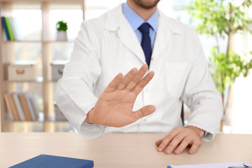 Male doctor refusing to take bribe at workplace