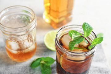 Two mason jars with Cuba Libre cocktail on table