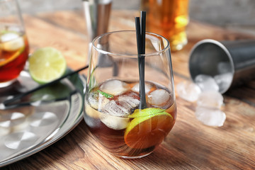 Glass of Cuba Libre cocktail on wooden table