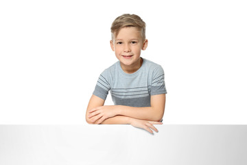 Cute boy with blank advertising board on white background