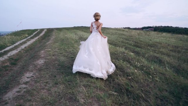 the bride is running down the hill
