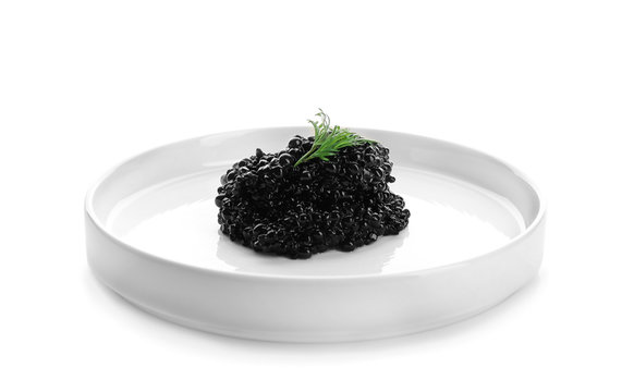 Black caviar on plate against white background