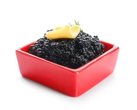 Black caviar in bowl on white background