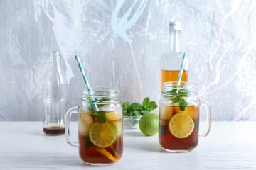 Mason jars with Cuba Libre cocktail on table