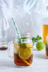 Mason jar with Cuba Libre cocktail on table